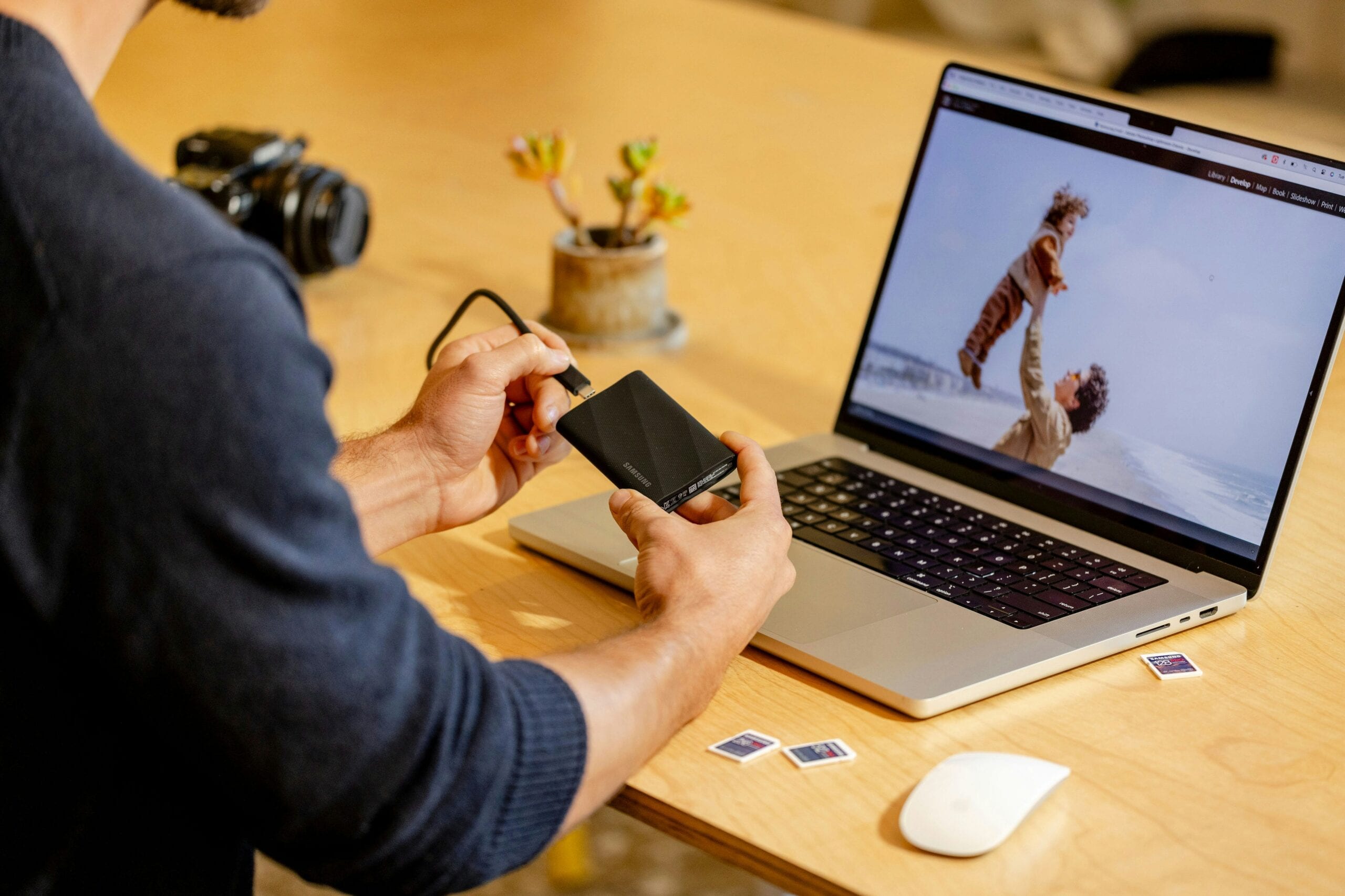 The-_Backup-Exit_-Strategy_-Can-You-Move-Your-Data-Without-the-Vendors-Help_-scaled.jpg A man sitting at a table with a laptop and cell phone